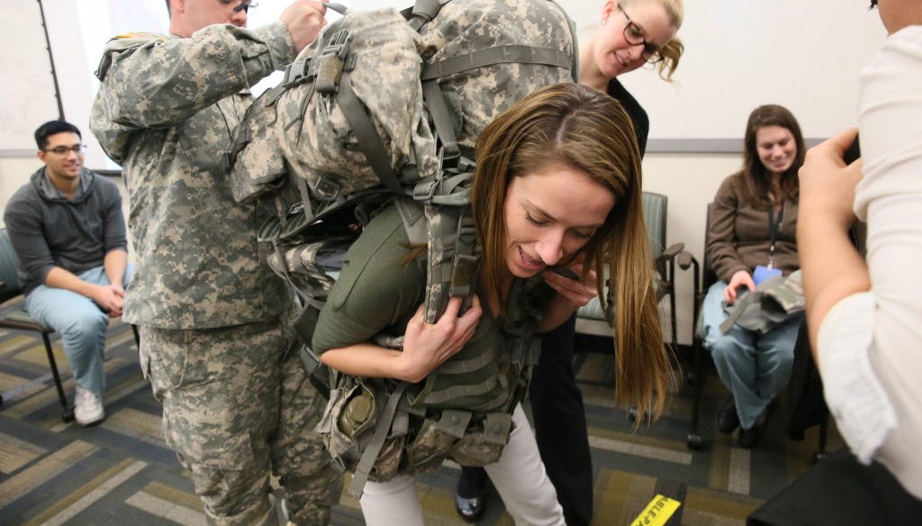 Students from the Medical College of Wisconsin learn from a medical recruiter for the Army about the physical demands on soldiers. (Michael Sears photo) 