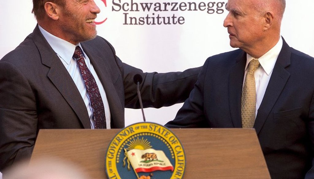 Former Gov. Arnold Schwarzenegger, left, shakes hands with Gov. Jerry Brown during a celebration of the 10th Anniversary of Schwarzenegger signing California's landmark global warming bill, AB32, Oct. 5, 2016, in Sacramento, Calif.