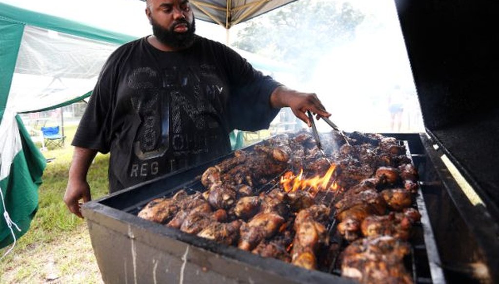 Emanual Dixon of St. Petersburg, Fla., turns over chicken, pork and beef ribs in his fire pit grill. Is the EPA planning to clamp down on such an all-American activity? (Octavio Jones/Tampa Bay Times)