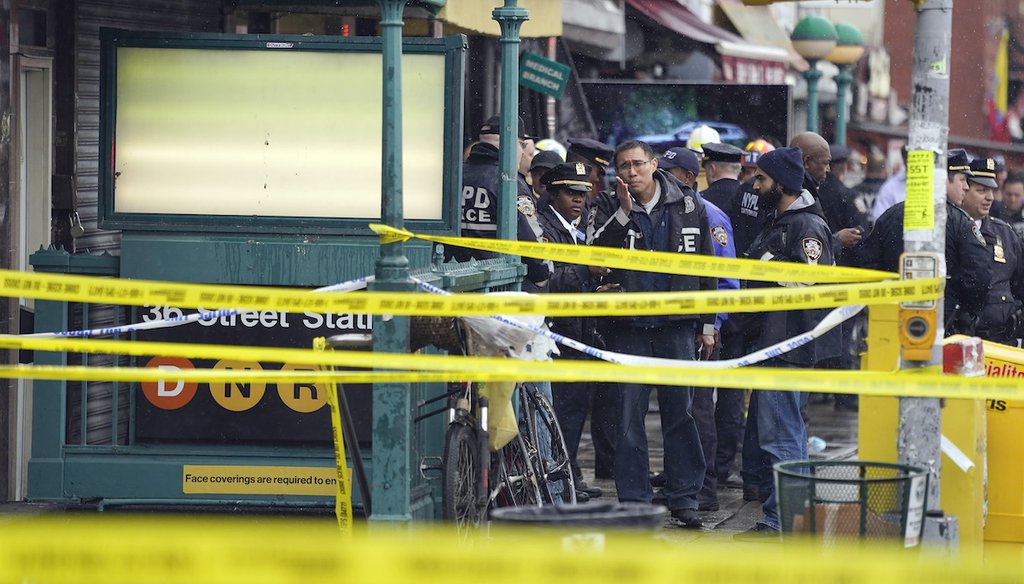 NYPD personnel gather at the entrance to a subway stop in Brooklyn, New York, on April 12, 2022. Multiple people were shot and injured at the subway station during a morning rush hour attack that left wounded commuters bleeding on a train platform. (AP)