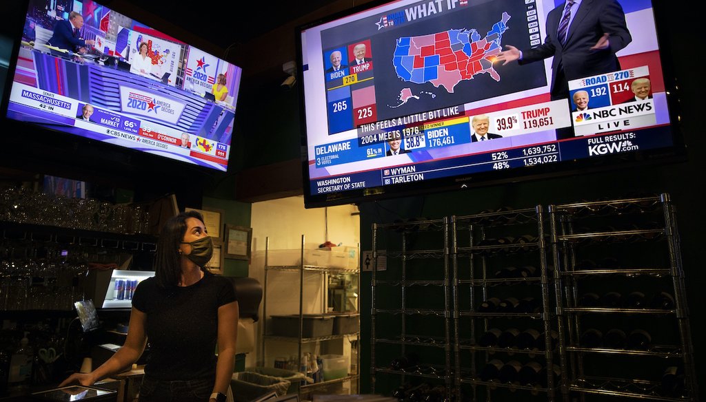 Bartender Sam Schilke watches election results on television at a bar and grill Tuesday, Nov. 3, 2020, in Portland, Ore. (AP)