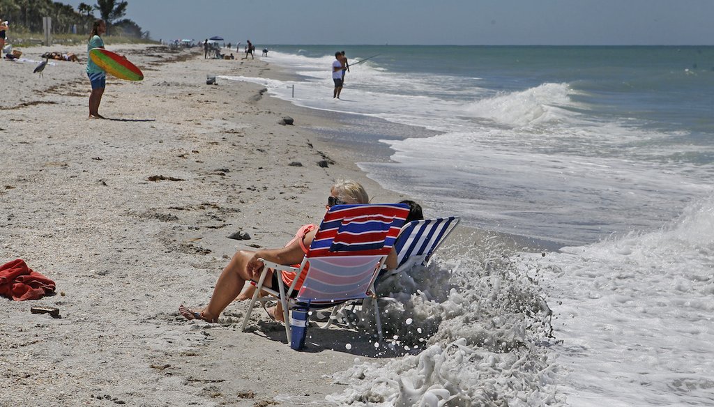 The high tide is encroaching on Marsha Hamlin, 58, and her daughter Courtney Hamlin, 23, who are vacationing from Indiana on Belleair Beach. (JIM DAMASKE | Times)