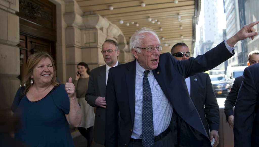 Democratic presidential candidate Sen. Bernie Sanders, I-Vt., and his wife Jane, gesture at supporters as they take a walk in New York's Times Square, Tuesday, April 19, 2016. (AP Photo/Mary Altaffer)