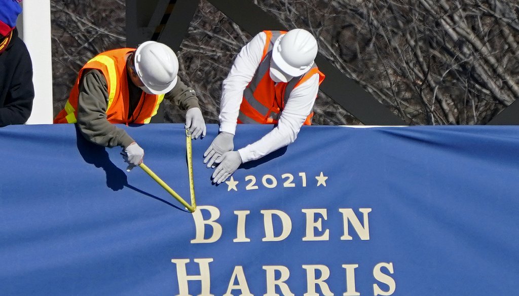 Workers put up bunting on a press riser for the upcoming inauguration of President-elect Joe Biden and Vice President-elect Kamala Harris, on Pennsylvania Ave. in front of the White House, Thursday, Jan. 14, 2021, in Washington. (AP)