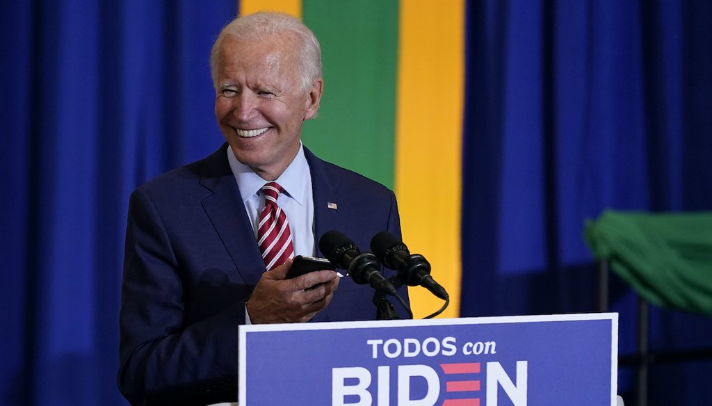 Democratic presidential candidate and former Vice President Joe Biden plays singer Luis Fonsi's "Despacito" on a phone before speaking at a Hispanic Heritage Month event on Sept. 15, 2020, at Osceola Heritage Park in Kissimmee, Fla. (AP/Semansky)