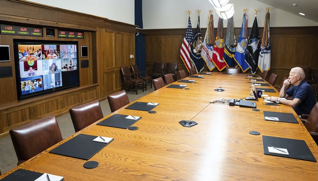 In a photo released by The White House, President Joe Biden meets virtually with his national security team on Afghanistan, Sunday, Aug. 15, 2021, at Camp David. The photo touched off unfounded conspiracy theories online. (The White House via AP)