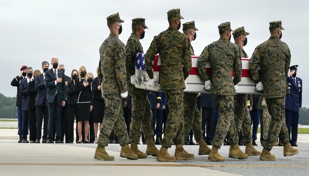 President Joe Biden and others look on as a carry team moves the remains of Marine Corps Lance Cpl. David L. Espinoza, 20,  at Dover Air Force Base on Aug. 29. Espinoza was one of 13 U.S. service members killed in Kabul, Afghanistan, on Aug. 26. (AP)