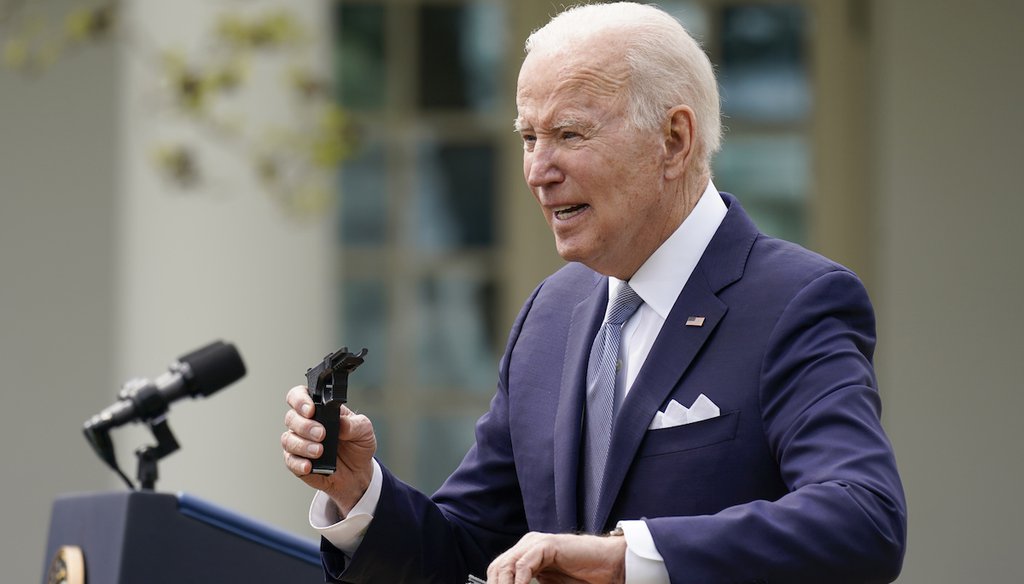 President Joe Biden holds pieces of a 9mm pistol as he speaks in the Rose Garden of the White House on April 11. (AP)