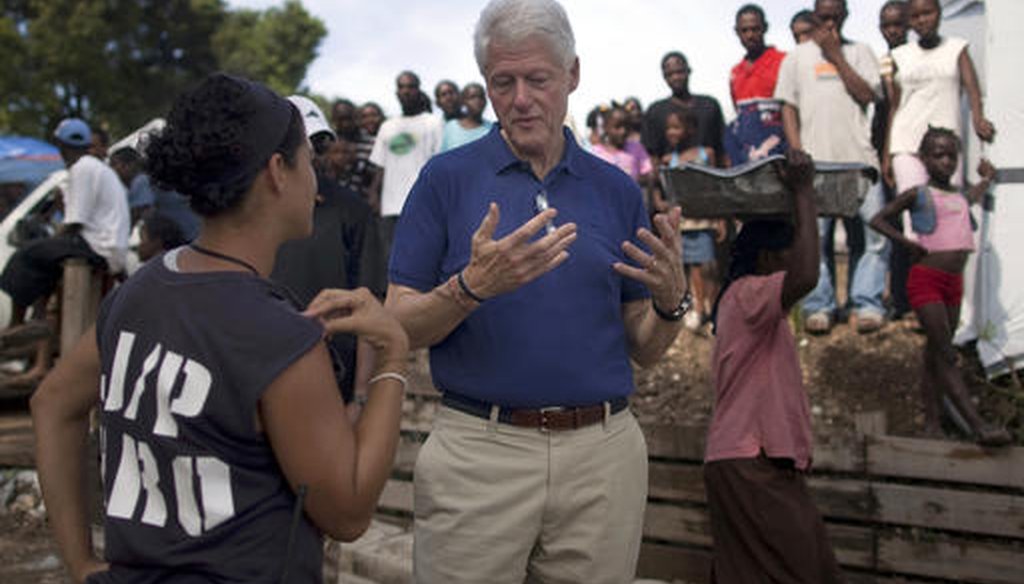 In this Oct. 6, 2010, file photo, former president and UN special envoy to Haiti, Bill Clinton, visits a camp for people who were displaced by the Jan. 12 earthquake in Port-au-Prince, Haiti. (AP)
