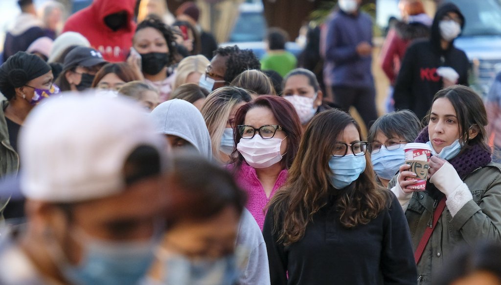 Black Friday shoppers wearing face masks wait to enter a store in Commerce, Calif., Nov. 26, 2021. (AP)