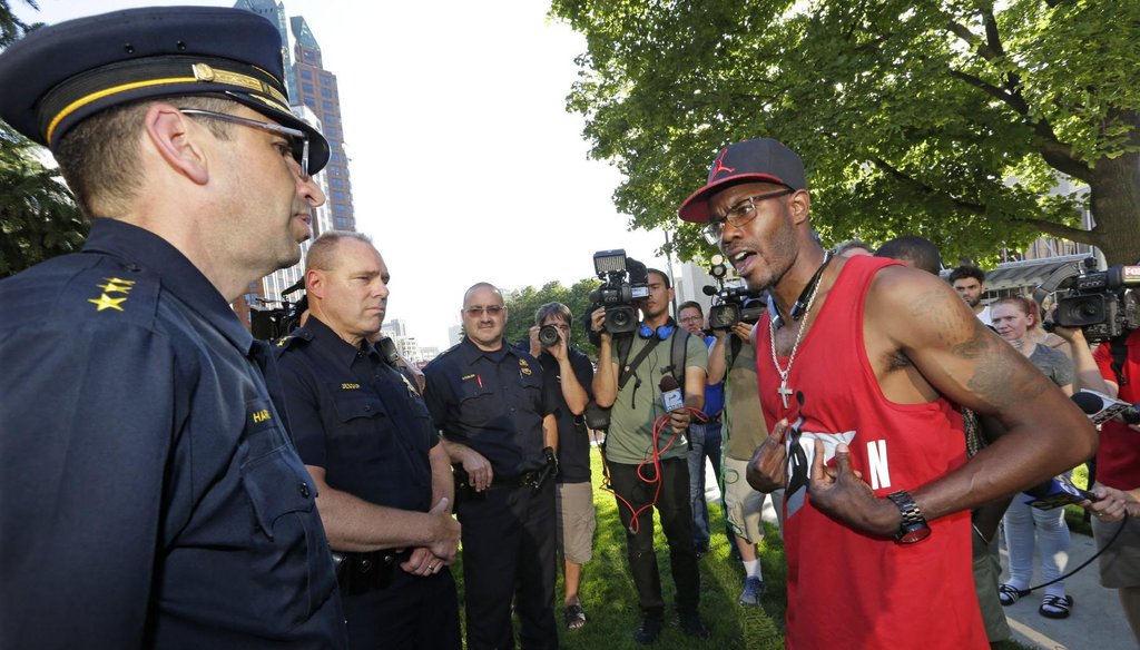 Nate Hamilton, the brother of Dontre Hamilton, who was killed by a Milwaukee police officer, talks with Milwaukee police during a Black Lives Matter rally in July 2016. (Milwaukee Journal Sentinel/Mike De Sisti)