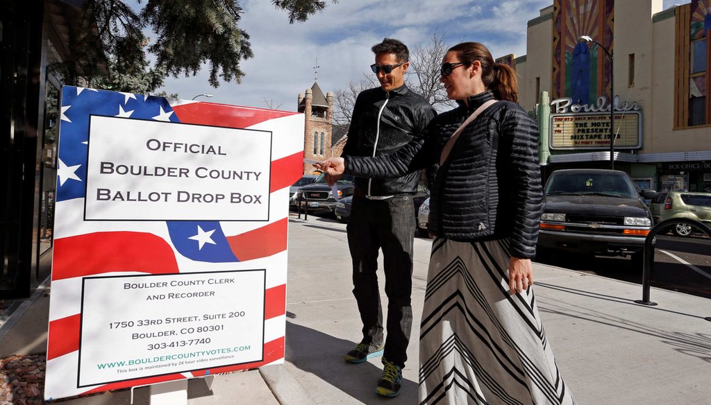 In the battle ground state of Colorado, Megan Monroe, right, and Brian Fuentes drop of their ballots at an electoral drop box, in Boulder, Colo. Ease of voting in Colorado means that almost half the state had voted four days before Election Day. (AP Photo