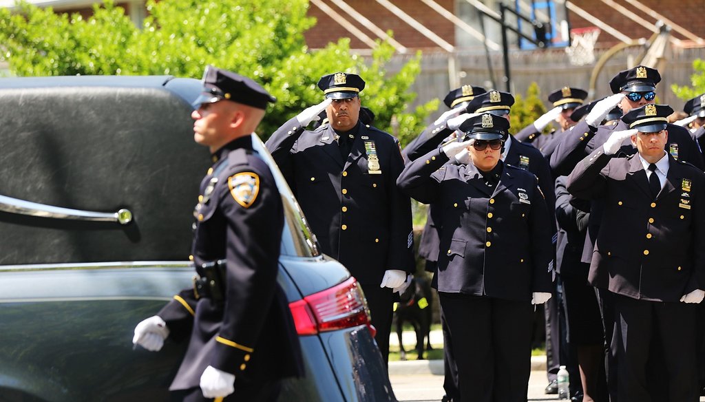 The hearse carrying fallen New York City police officer Brian Moore leaves church on May 8. Ph