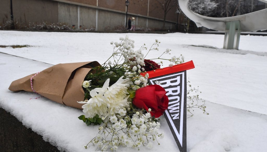 A bouquet of flowers rests on snow, Sunday, Dec. 14, 2025, on the campus of Brown University not far from where a shooting took place, in Providence, R.I. (AP)