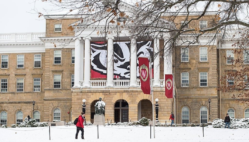 A banner with a graphic of mascot Bucky Badger's face hung between the columns of Bascom Hall at the University of Wisconsin-Madison on Nov. 25, 2014. (UW-Madison photo)