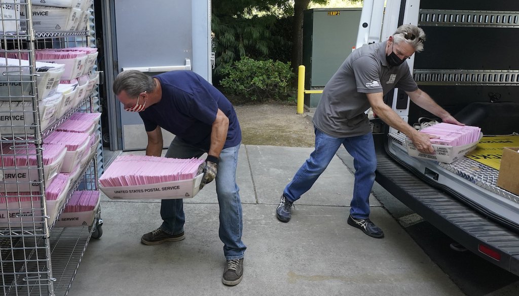 In this Aug. 30, 2021 file photo, Tim Rasmussen, left and Karl Vostrez, right deliver mail-in ballots for the Sept. 14th, recall election at the Sacramento County Registrar of Voters office in Sacramento, Calif. (AP)