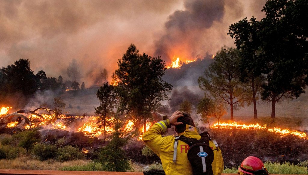 A firefighter rubs his head while watching the LNU Lightning Complex fires spread through the Berryessa Estates neighborhood of unincorporated Napa County, Calif., on Friday, Aug. 21, 2020. Noah Berger / AP Photo