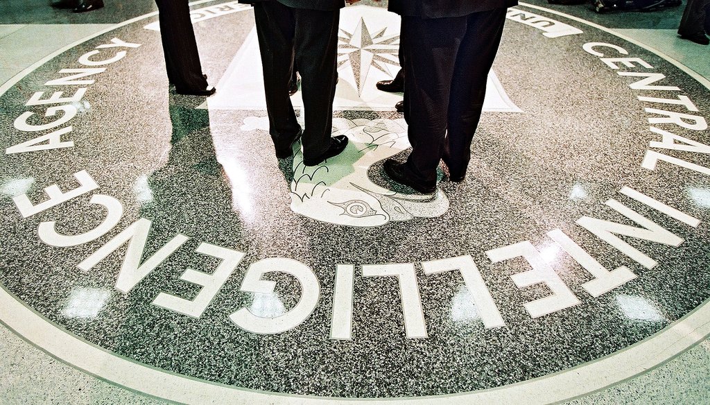 President George W. Bush and CIA Director George Tenet stand on the agency's seal at CIA headquarters in Langley, Va., March 20, 2001. The Senate released a report on a CIA interrogation program under Bush last week.