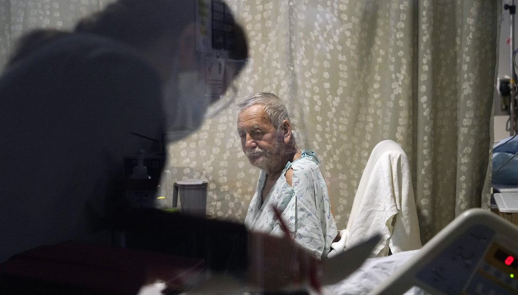 Jesus Aguirre Medina, a COVID-19 patient, looks on as a nutritionist looks over paperwork in his room in the acute care unit of Harborview Medical Center, Friday, Jan. 14, 2022, in Seattle. (AP)