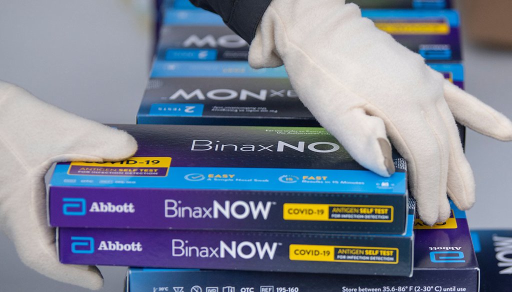 A Youngstown City Health Department worker grabs two at-home COVID-19 test kits Dec. 30, 2021, in Youngstown, Ohio. (AP)