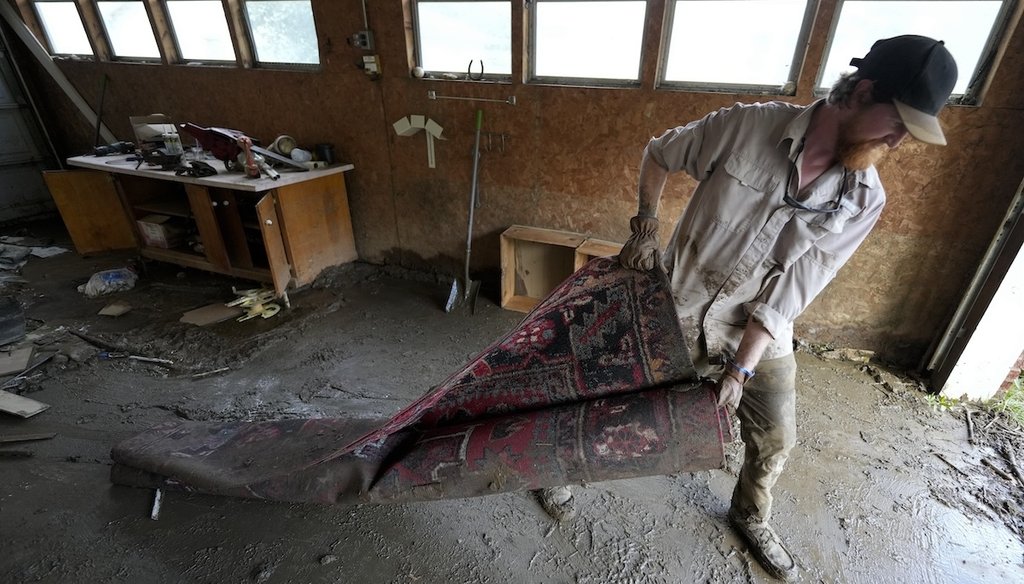 Grayson Jones cleans up after on Oct. 3, 2024, in Vilas, North Carolina, in the aftermath of Hurricane Helene. (AP)