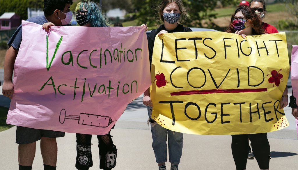 San Pedro High School students hold vaccination signs at a school-based COVID-19 vaccination event for students 12 and older in San Pedro, Calif., Monday, May 24, 2021. (AP)