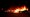Cars set ablaze amid violent protests burn at the Car Source in Kenosha on Aug. 24, 2020. (Photo by KAMIL KRZACZYNSKI / AFP)