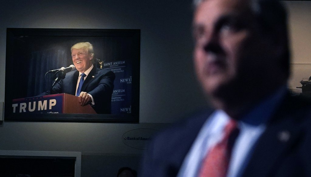 A photograph of former President Donald Trump hangs on the wall as Republican presidential candidate, former New Jersey Gov. Chris Christie listens to a question during a gathering, Tuesday, June 6, 2023, in Manchester, N.H. (AP)