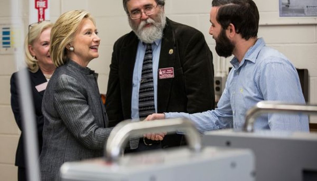 Democratic presidential hopeful Hillary Clinton meets with professor Robert Arredondo and student Travis Lemieux in an engineering lab before a roundtable conversation at New Hampshire Technical Institute-Concord Community College on April 21, 2015.