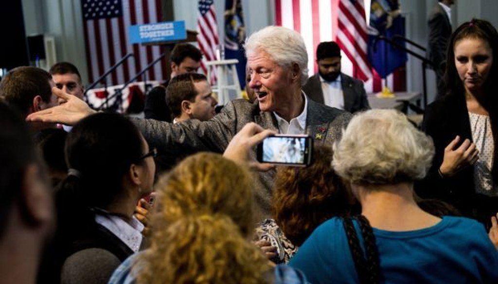 Former President Bill Clinton reaches out to shake hands after speaking to nearly 500 people on Oct. 3, 2016, at Northbank Center in Flint, Mich. (Jake May/Flint Journal via AP) 