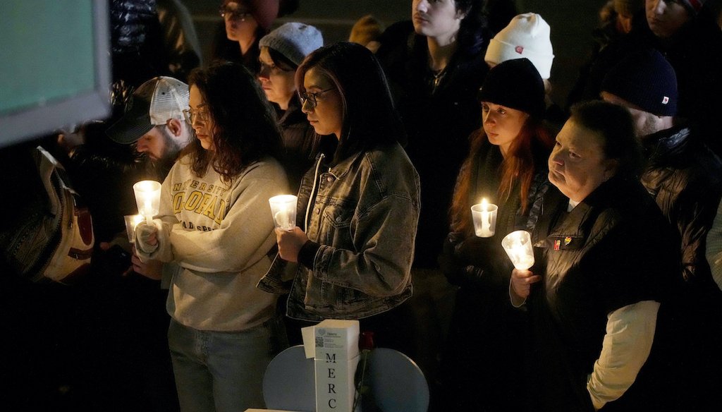 Mourners hold candles during a vigil at a makeshift memorial to mark Saturday's mass shooting at Club Q, late Monday, Nov. 21, 2022, in Colorado Springs, Colorado. (AP)