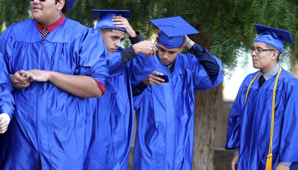 These four young men graduated from a Los Angeles high school in June 2013. If they opt for college, will it take them six years to earn a four-year degree? (Los Angeles Times/MCT photo)