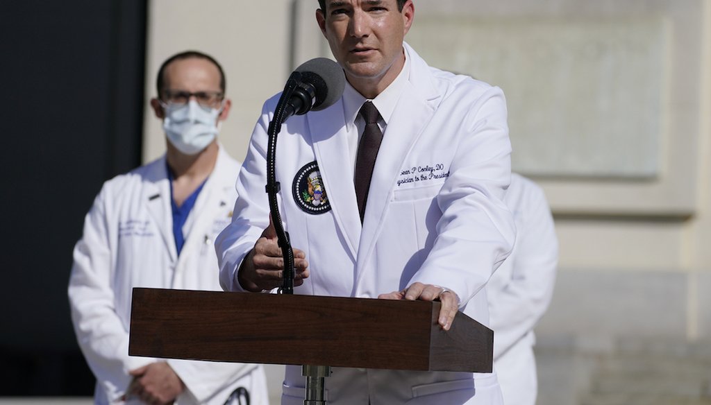 Dr. Sean Conley, physician to President Donald Trump, talks with reporters at Walter Reed National Military Medical Center. (AP Photo/Evan Vucci)