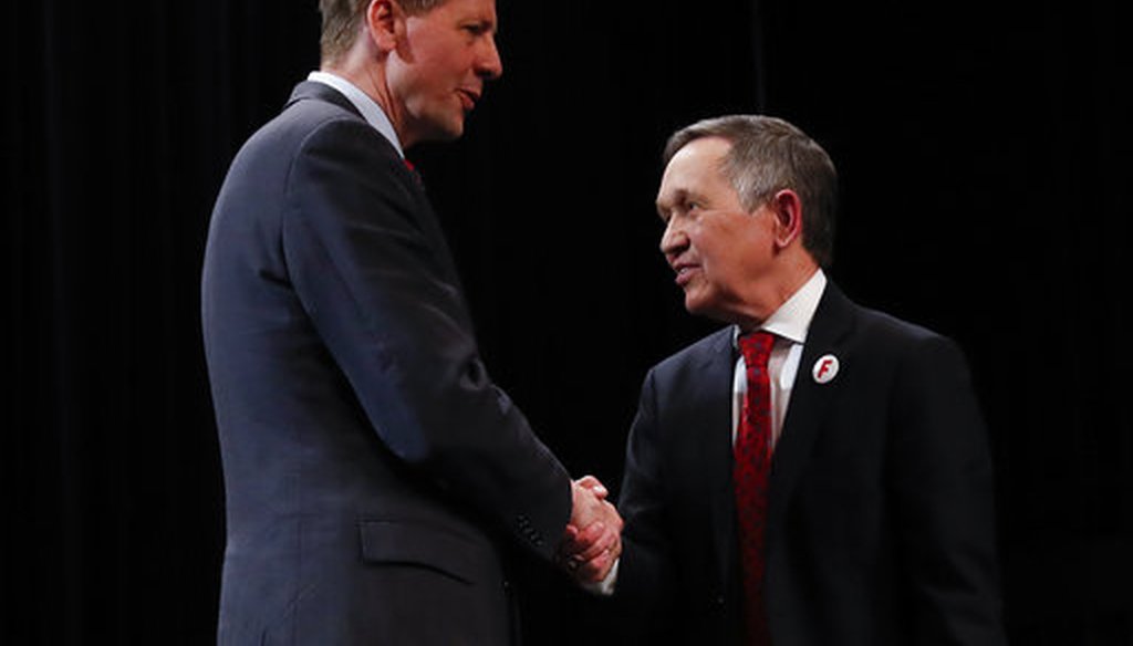Richard Cordray, former federal consumer protection chief, left, and former U.S. Rep. Dennis Kucinich, right, shake hands after the Ohio Democratic Party debate in the primary race for governor,  April 10, 2018, at Miami (Ohio) University. (AP)