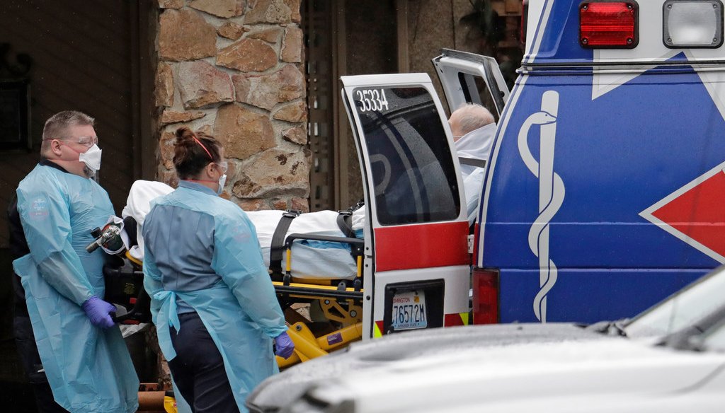 Ambulance workers move a man on a stretcher from the Life Care Center in Kirkland, Wash. into an ambulance, Friday, March 6, 2020. The facility is the epicenter of the outbreak of the the COVID-19 coronavirus in Washington state. (AP Photo/Ted S. Warren)