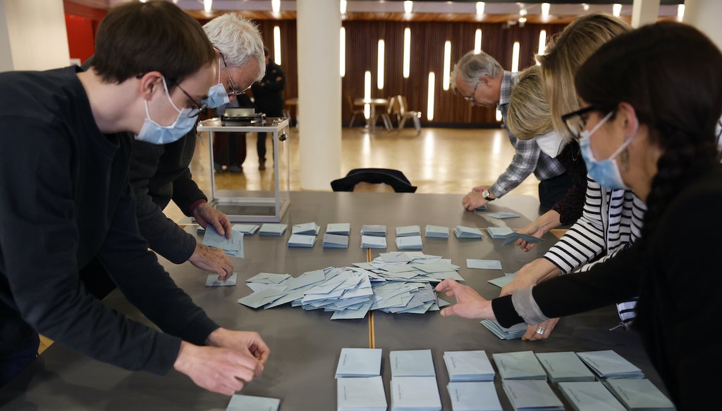 Voting station volunteers count ballots box in the first round of the French presidential election, in Strasbourg, eastern France, Sunday, April 10, 2022. (AP)