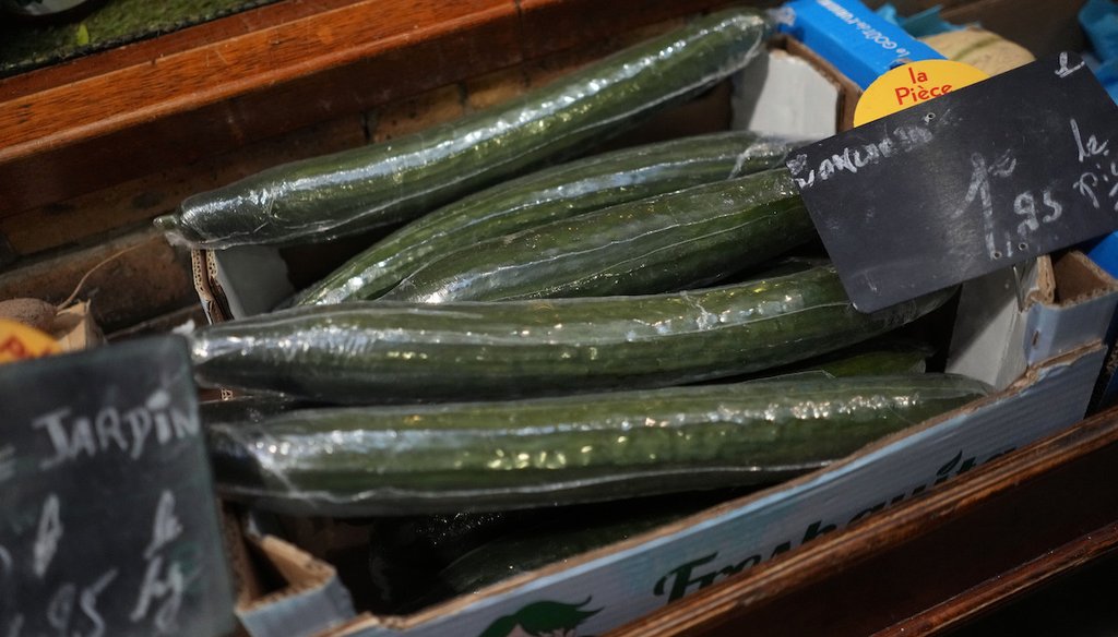 Cucumbers wrapped in plastic package are on display on a grocery stall in Paris, Friday, Dec. 31, 2021. (AP)