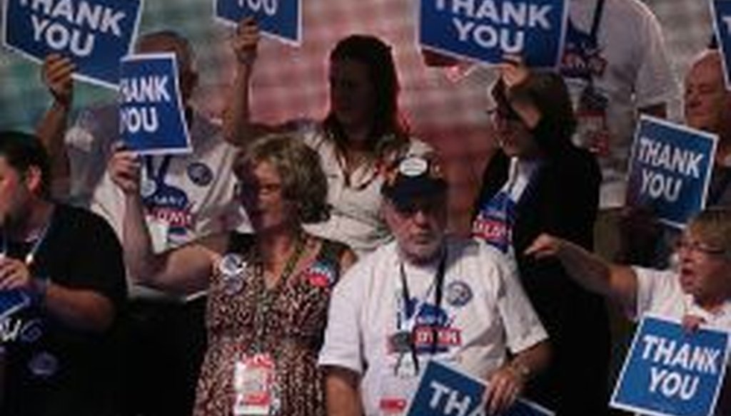 Delegates hold up "Thank You" signs during day three of DNC in Charlotte on Thursday. President Obama's nomination acceptance speech was aimed at convincing voters that a slow economic recovery will accelerate if they give him a second term.