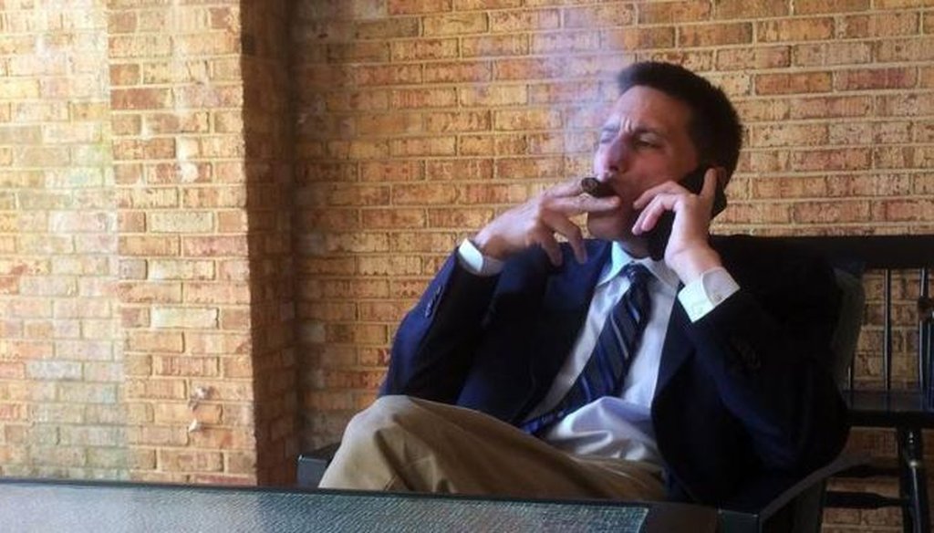 Dallas Woodhouse, executive director of the North Carolina Republican Party, takes a smoke break outside his office while checking in with party officials. (Courtesy of N&O/Bryan Anderson)