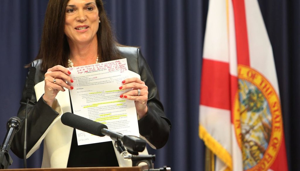  Rep. Dana Young, R- Tampa, shows a copy of her gaming bill to members of the media.