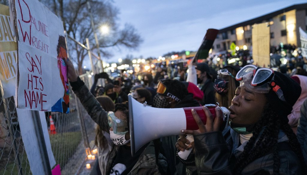 Demonstrators gather along a perimeter fence during a protest over Sunday's fatal shooting of Daunte Wright during a traffic stop, outside the Brooklyn Center Police Department on Wednesday, April 14, 2021, in Brooklyn Center, Minn.