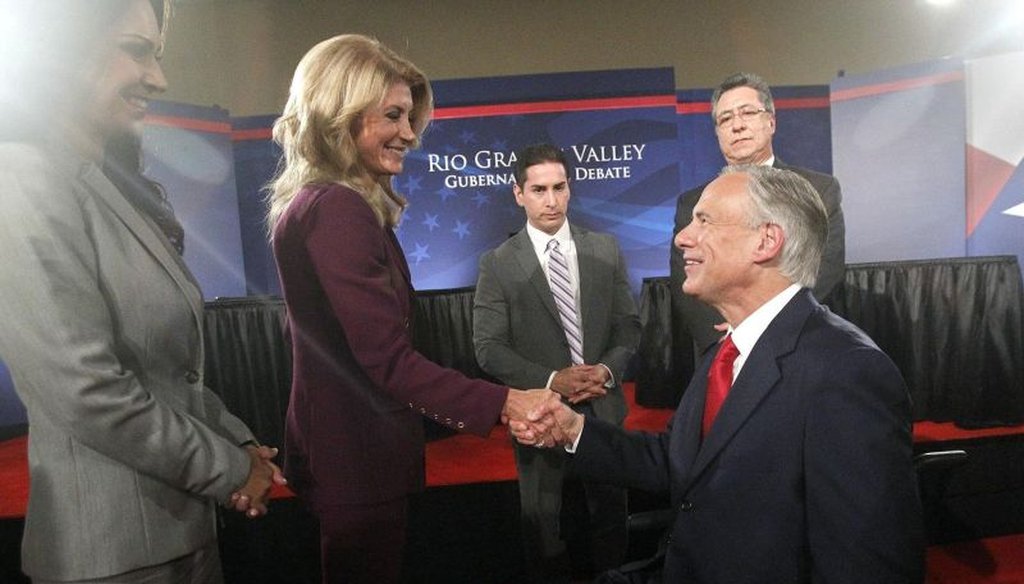 Texas state Sen. Wendy Davis shakes hands with Texas Attorney General Greg Abbott after a debate on Sept. 19, 2014. (AP photo)