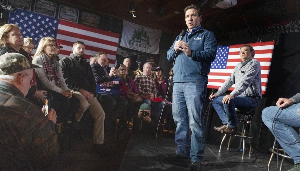 Republican presidential candidate Florida Gov. Ron DeSantis speaks during a campaign event at Wally's bar as Rep. Thomas Massie, R-Ky, right, watches, Wednesday, Jan. 17, 2024, in Hampton, N.H. (AP)