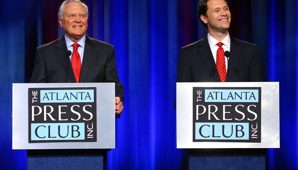 Republican Gov. Nathan Deal, left, and his Democratic rival, state Sen. Jason Carter, smile at a question during the Atlanta Press Club debate on Oct. 19. CURTIS COMPTON PHOTOS / AJC