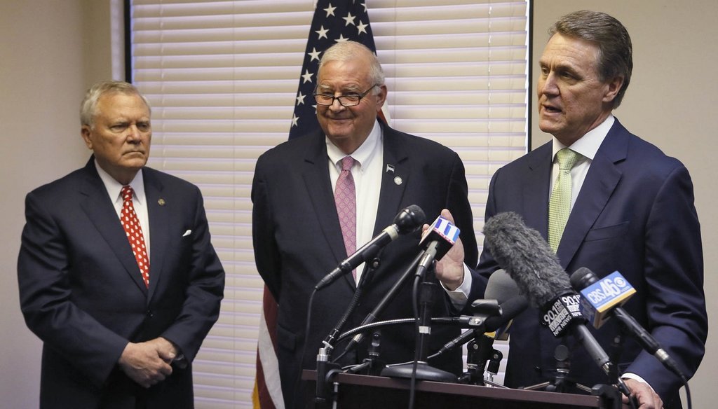 Senator-elect David Perdue (right) reacts to a question during a press conference with Gov. Nathan Deal (left) and Georgia GOP Chairman John Padgett. Photo by Bob Andres/ AJC.