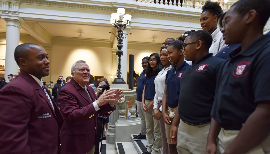Gov. Nathan Deal greets students from Utopian Academy after signing House Bill 372 to persuade voters to support his plan to allow the state takeover of Georgia’s failing schools. Photo by Hyosub Shin / AJC
