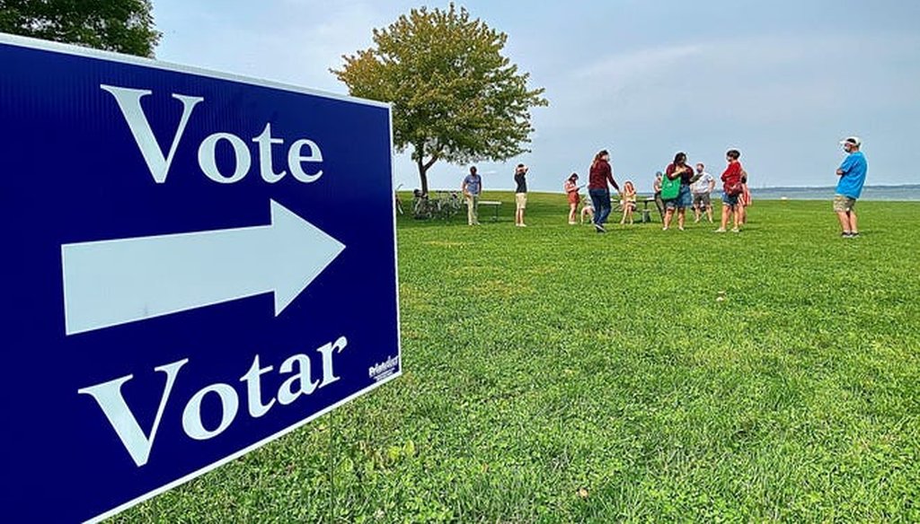 Voters turn in their absentee ballots to poll workers at James Madison Park in Madison on Sept. 27, 2020. (Photo by Elizabeth Beyer/Wisconsin State Journal)