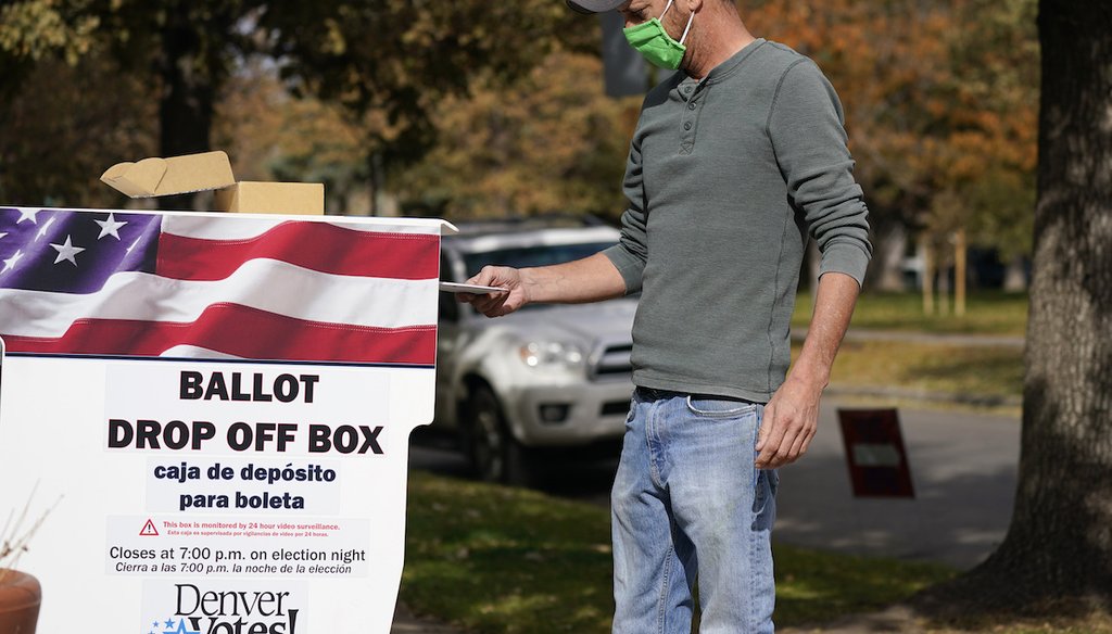 A voter casts a ballot in a dropbox Nov. 3, 2020, in Denver. (AP Photo/David Zalubowski)