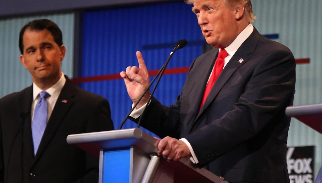 Gov. Scott Walker is shown in the background as Donald Trump speaks during the first 2016 Republican presidential debate on Aug. 6, 2015. (Andrew Harnik photo)