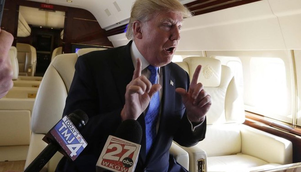 Donald Trump speaks with reporters on his plane before addressing a rally for his presidential campaign in Janesville, Wis., on March 29, 2016. (Rick Wood photo)